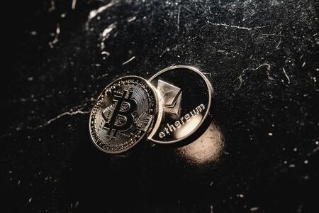 Bitcoin on a dark background. Ethereum and bitcoin rise and fall in price.の写真素材