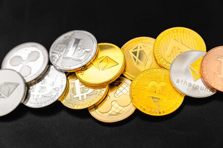 Bitcoin on a dark background. Many cryptocurrency coins on black background.の写真素材