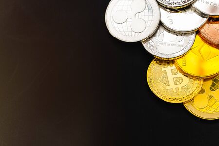 Bitcoin on a dark background. Many cryptocurrency coins on black background.の写真素材