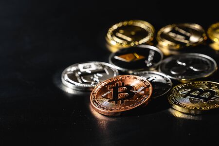 Bitcoin on a dark background. Many cryptocurrency coins on black background.の写真素材