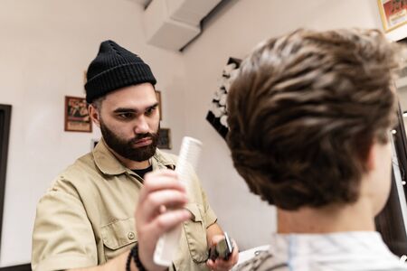 The client receives a haircut in a barbershop. Mens Hair Care.の写真素材