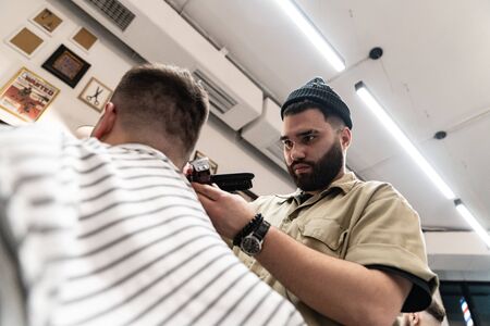 The client receives a haircut and hair styling in a beauty salon.の写真素材