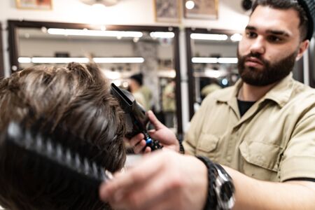 Creating a new hairstyle. Creative haircut from a hairdresser.の写真素材