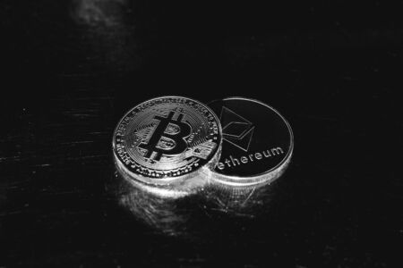 Bitcoin on a dark background. Ethereum and bitcoin rise and fall in price.の写真素材