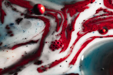 Color macro abstraction. Macro world and texture of liquid with the addition of paint. Abstract background from ink, milk and oilの写真素材