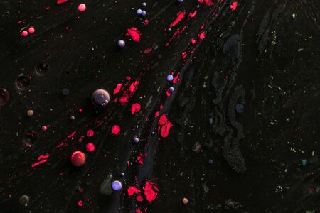 Amazing multi colored bubbles of paint on the oil surface.の写真素材