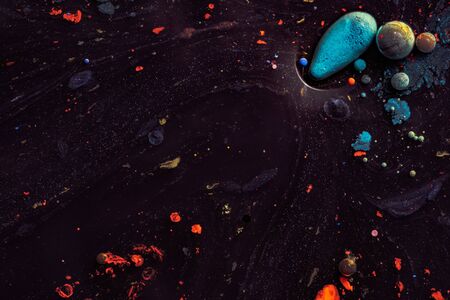 Amazing multi colored bubbles of paint on the oil surface.