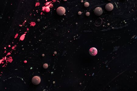 Stains of paint on the water surface. Abstract acrylic bubbles. Macro photo.の写真素材