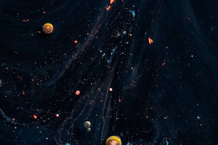 Paint in water. Amazing macro photography in the form of space and planets.の写真素材