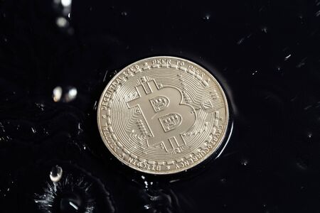 Cryptocurrency coins on a dark background. Rain drops on coins.の写真素材