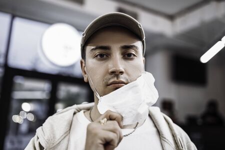A man puts on a mask from a virus. Flu epidemic.の写真素材