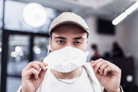 A man puts on a mask from a virus. Flu epidemic.の写真素材