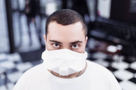 A man puts on a mask from a virus. Flu epidemic.の写真素材
