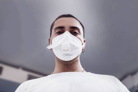 A man puts on a mask from a virus. Flu epidemic.の写真素材