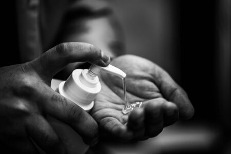 Use of antiseptic. Black and white contrast photo.の写真素材