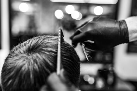 Barber and client in mask against virus. Haircut in quarantine.の写真素材