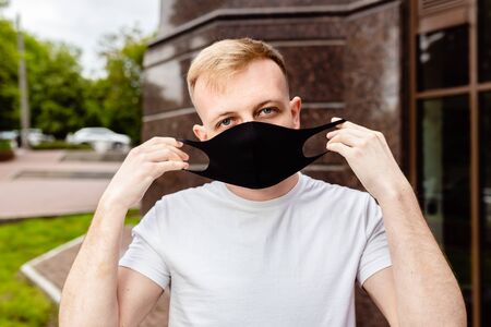 A man in a black mask. Quarantine in the city.の写真素材