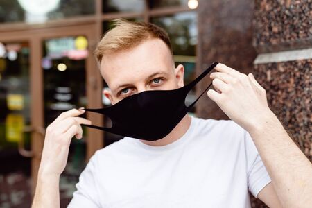 A man in a black mask. Quarantine in the city.の写真素材
