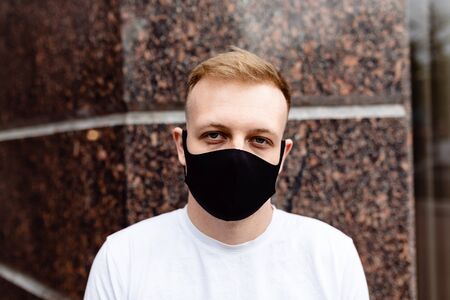 A man in a black mask. Quarantine in the city.の写真素材