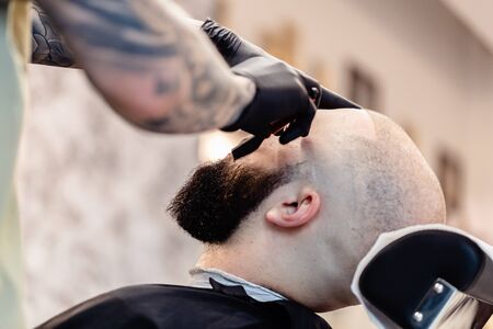 Beard haircut in a barber shop. Beard care.の写真素材