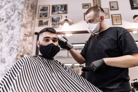 Haircut in quarantine. Haircut in masks from the virus. Hair and health care.の写真素材