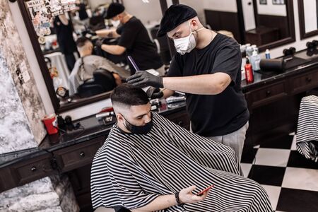 Haircut in quarantine. Haircut in masks from the virus. Hair and health care.の写真素材