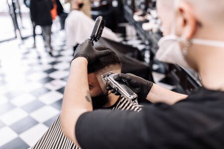 Haircut in quarantine. Haircut in masks from the virus. Hair and health care.の写真素材