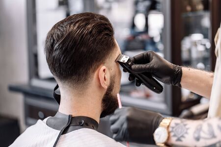 Classic haircut in a barbershop. Curve hair styling and hair health care in a barbershop.の写真素材