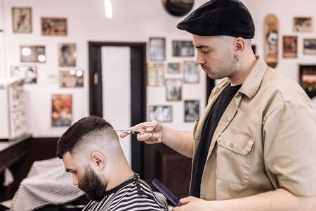 Classic haircut in a barbershop. Curve hair styling and hair health care in a barbershop.の写真素材