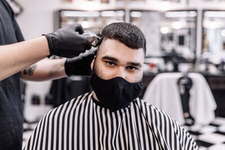 Haircut in quarantine. Haircut in masks from the virus. Hair and health care.の写真素材