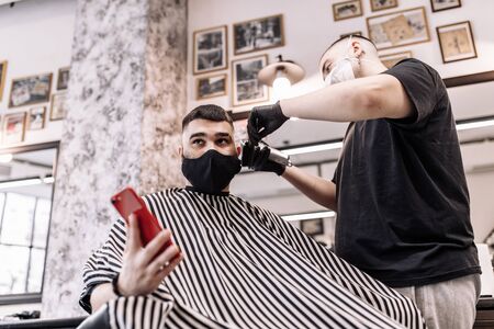 Haircut in quarantine. Haircut in masks from the virus. Hair and health care.の写真素材