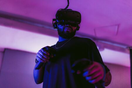 The guy is playing VR games. Neon blue light.の写真素材
