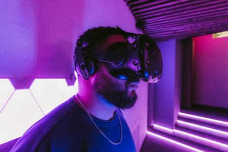 The guy is playing VR games. Neon blue light.の写真素材