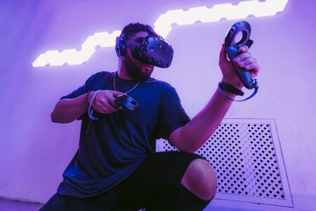 The guy is playing VR games. Neon blue light.の写真素材