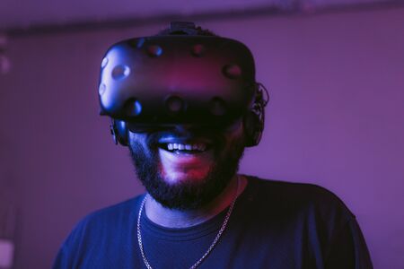 The guy is playing VR games. Neon blue light.の写真素材