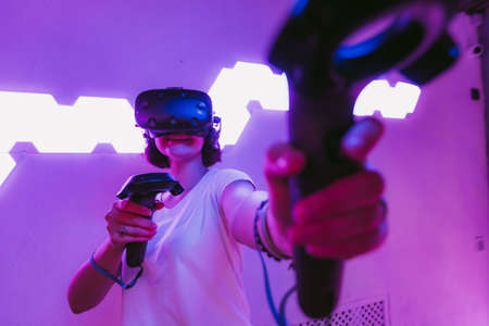 Girl playing virtual reality games. Home entertainment.の写真素材