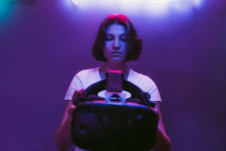 The girl connects to augmented reality. Neon room.の写真素材