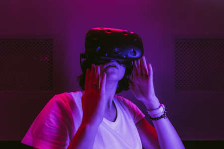 Surprised girl in virtual reality. Cyberpunk games.の写真素材