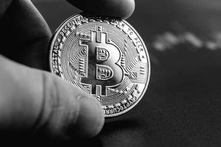 Bitcoin in hands close-up. Cryptocurrency rate.の写真素材