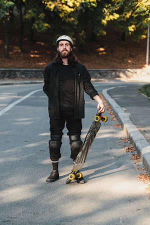 Lifestyle style of sketching, longboard. Portrait of a bearded guy with a board.の写真素材