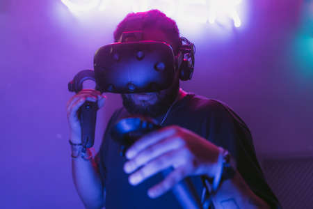 The guy is playing VR games. Neon blue light.の写真素材