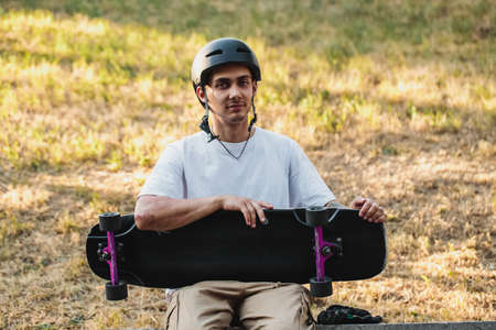 Portrait of a guy with a board in his hands.の写真素材