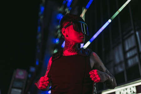 Cyberpunk style. Tattooed guy in one city. Cyber glasses.の写真素材