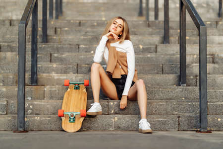 Beautiful woman skates around the city. Lifestyle and summer vacation.