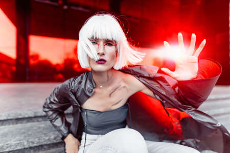 Futuristic fashion. Blonde on a red futuristic background.の写真素材