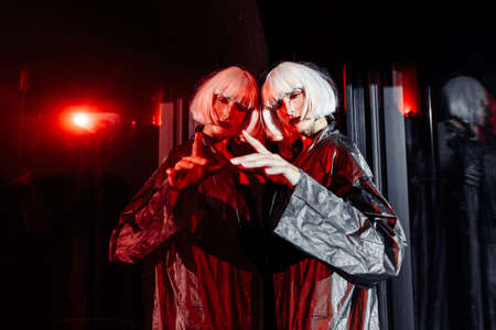 Fashion of the future. Futuristic blonde in red space.の写真素材