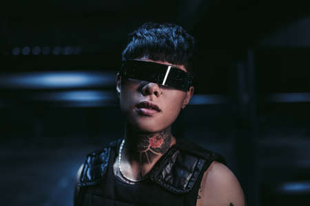 Man in futuristic glasses in a neon night city.の写真素材