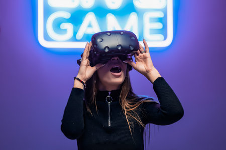 The player is surprised during the VR game. Neon sign gameの写真素材