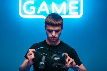 Young man holding VR glasses. Strat games.の写真素材