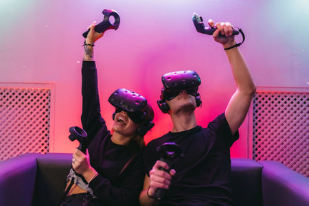 VR Battle on the couch. People spend time in the game.の写真素材